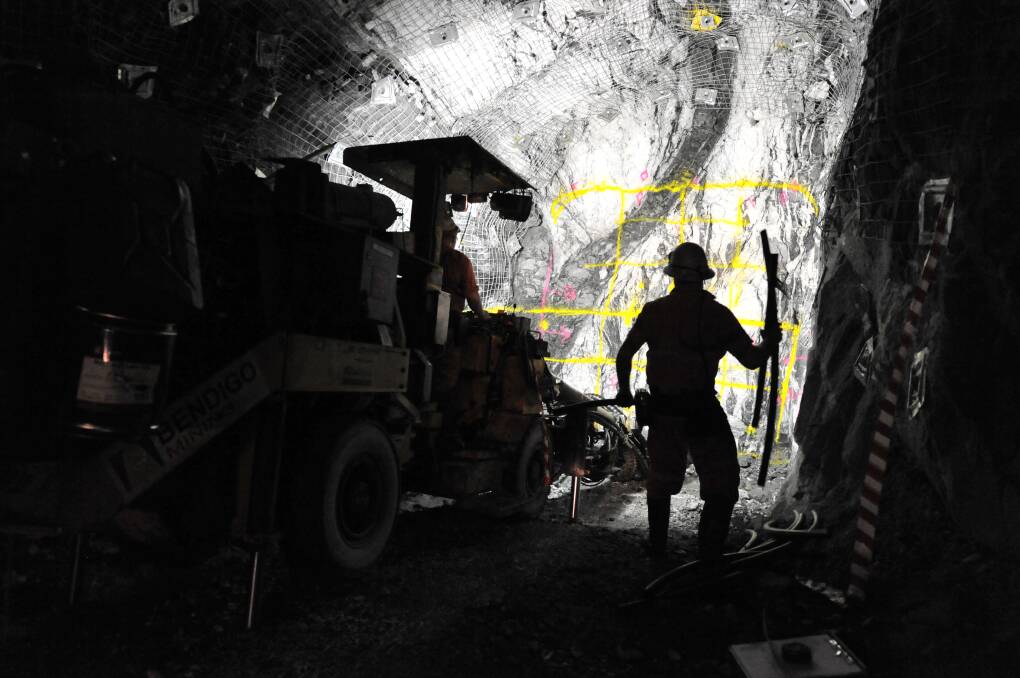 Underground miners prepare a new rockface for blasting. Picture: BILL CONROY