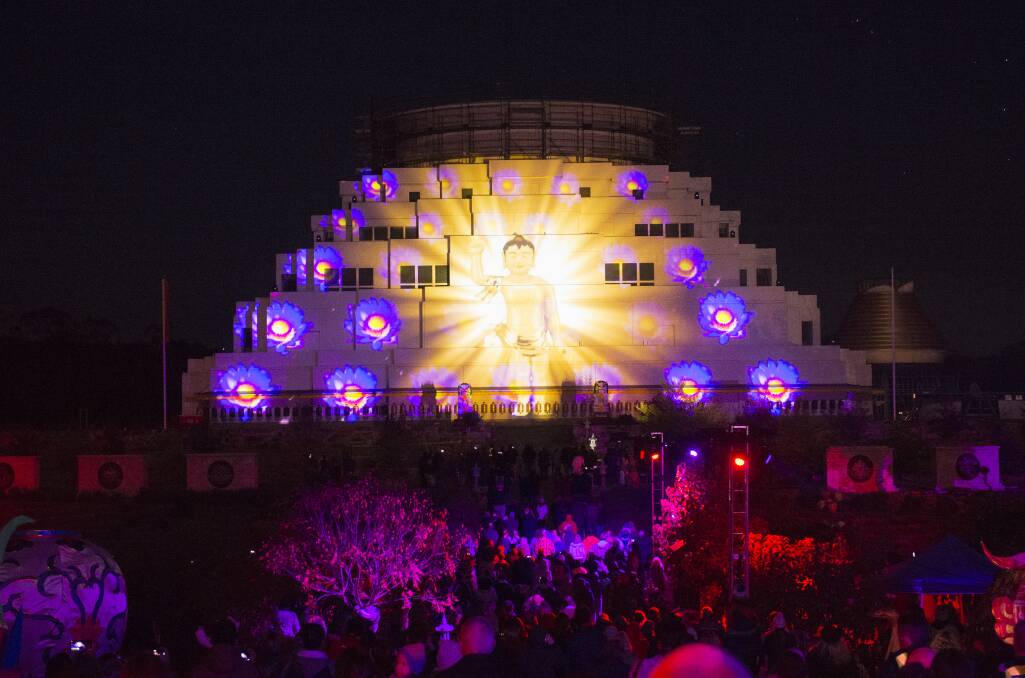 Crowds watch a light show on the walls of the Great Stupa in 2019. Picture: Darren Howe