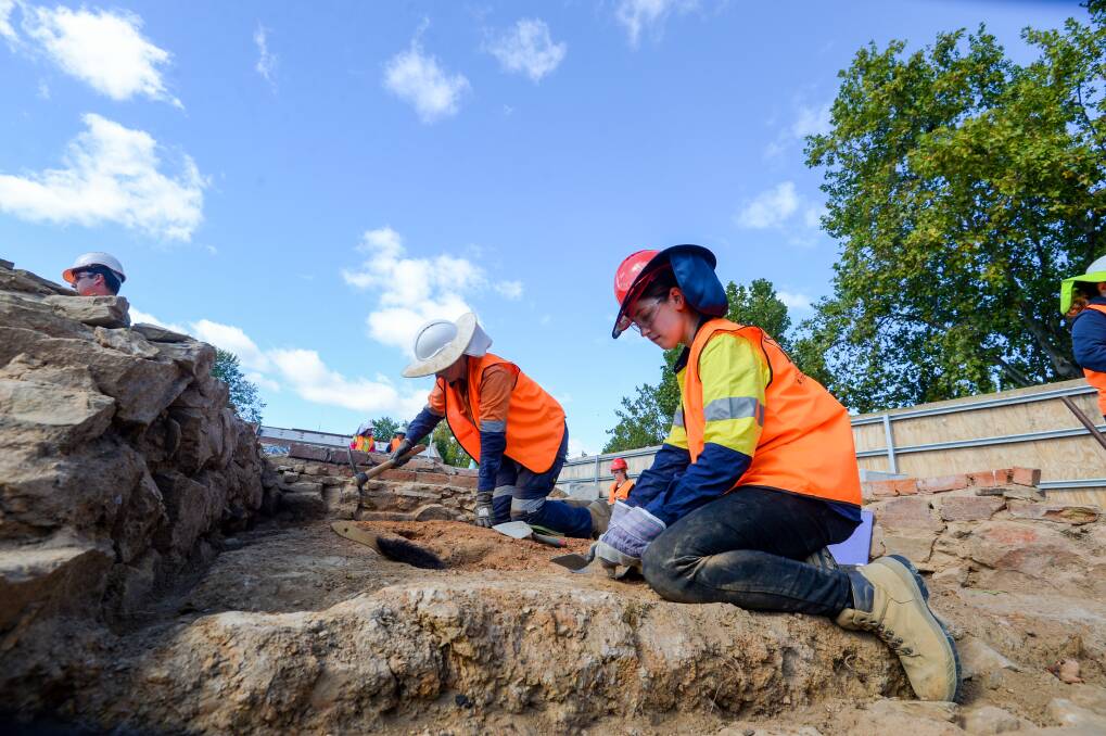 Archaeologists carefully sift through part of the Lyttleton Terrace site. Picture: DARREN HOWE