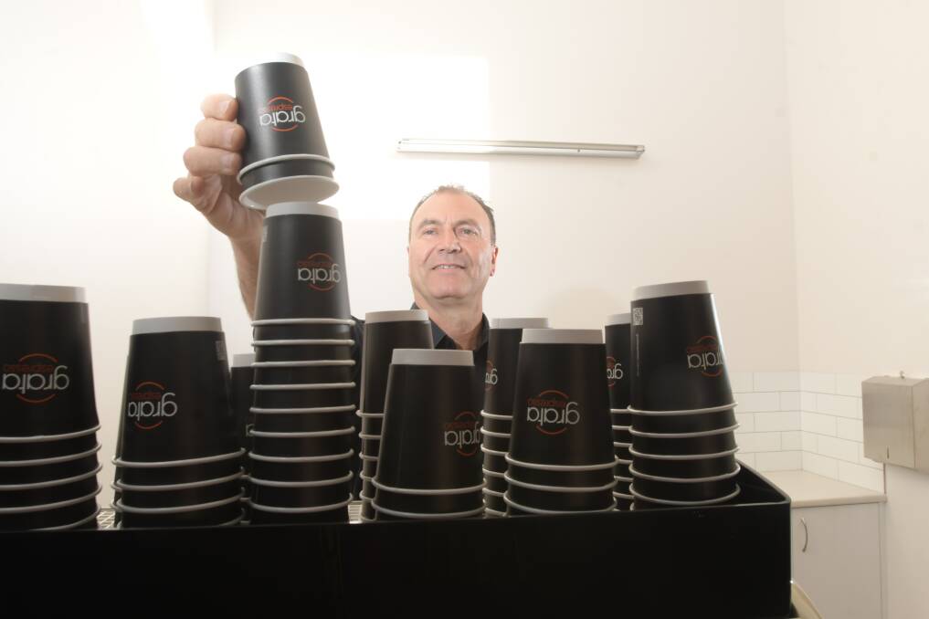 Carlo Barri with his coffee machine in the new cafe. Picture: NONI HYETT