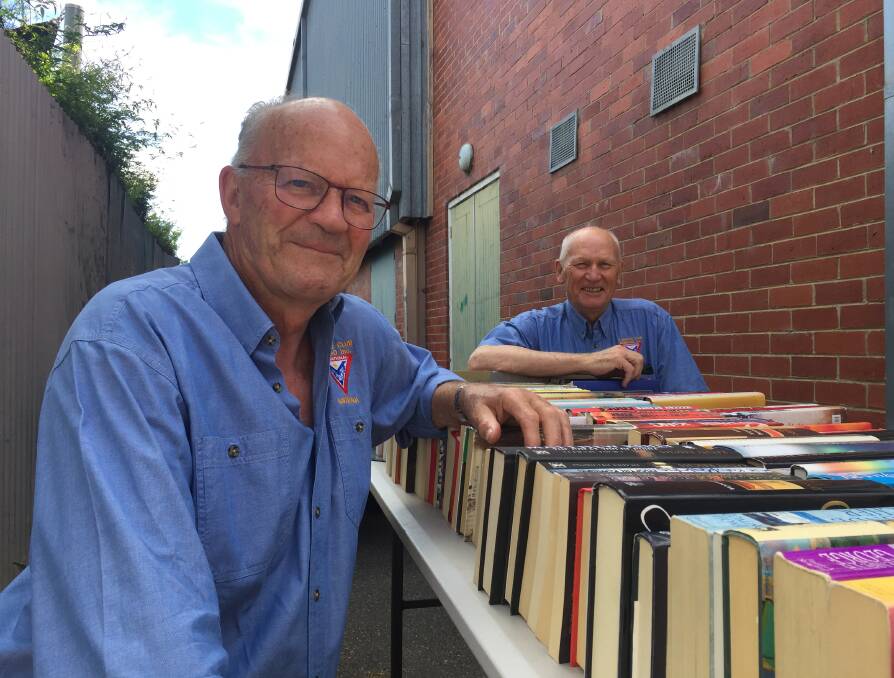 BACK TO THE BOOKS: The Y Service Club of Bendigo's president-elect Peter Searle and treasurer Colin Lambie prepare for this weekend's sale. Picture: TOM O'CALLAGHAN