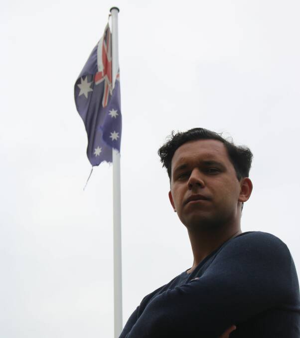 Proud history: Mathew Evans with the flag his great-grandfather co-designed. Picture: Evan Evans