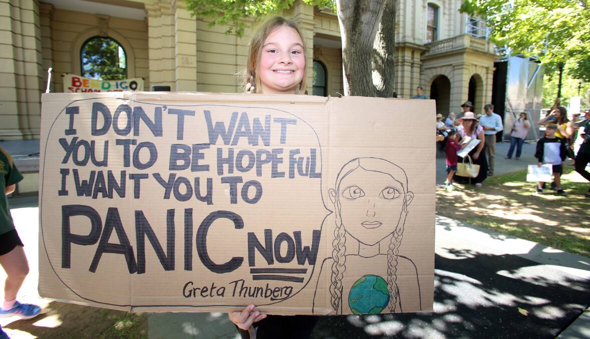 Global and local: Hundreds of students marched through the streets of Bendigo seeking action on climate change. Picture: GLENN DANIELS