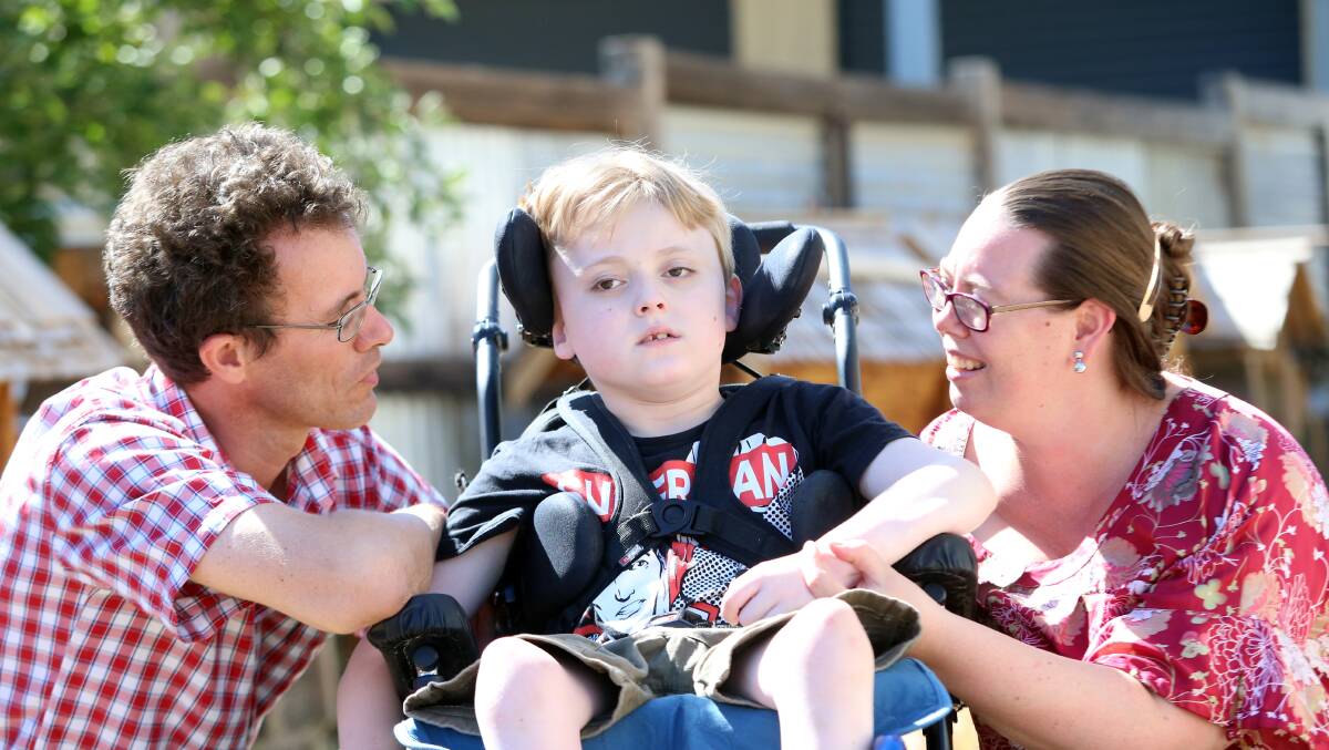 Ten-year-old Ēadweard Chignell with his parents, Sarah and Stuart. The Chignells took part in a trial transport service to get Ēadweard to the Very Special Kids hospice free of charge last year, and it is now being rolled out across Victoria. Picture: GLENN DANIELS