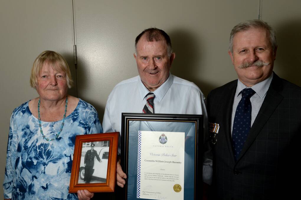TRIBUTE: Bill Harnetty, centre, with his father's Victoria Police Star certificate.