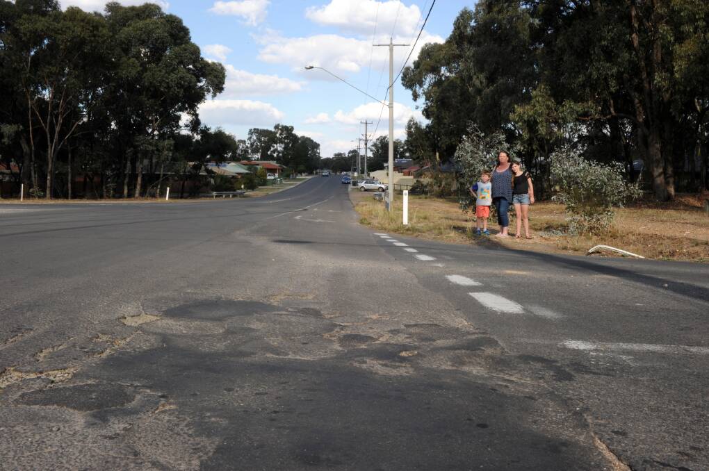 DANGEROUS: Maree Ryan at the intersection of Jobs Gully Road and Averys Road with her two children Dakota and Chase Woodhatch. Ms Ryan says the intersection is a disaster waiting to happen. Picture: NONI HYETT