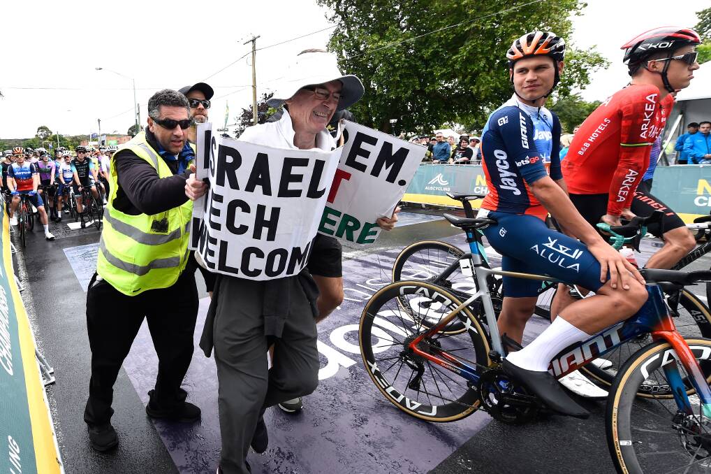 Police and security are quick to react to pro-Palestine protesters that crashed the start line of the AusCycling Road National Championships elite men's race in Buninyong on January 7. Picture by Adam Trafford