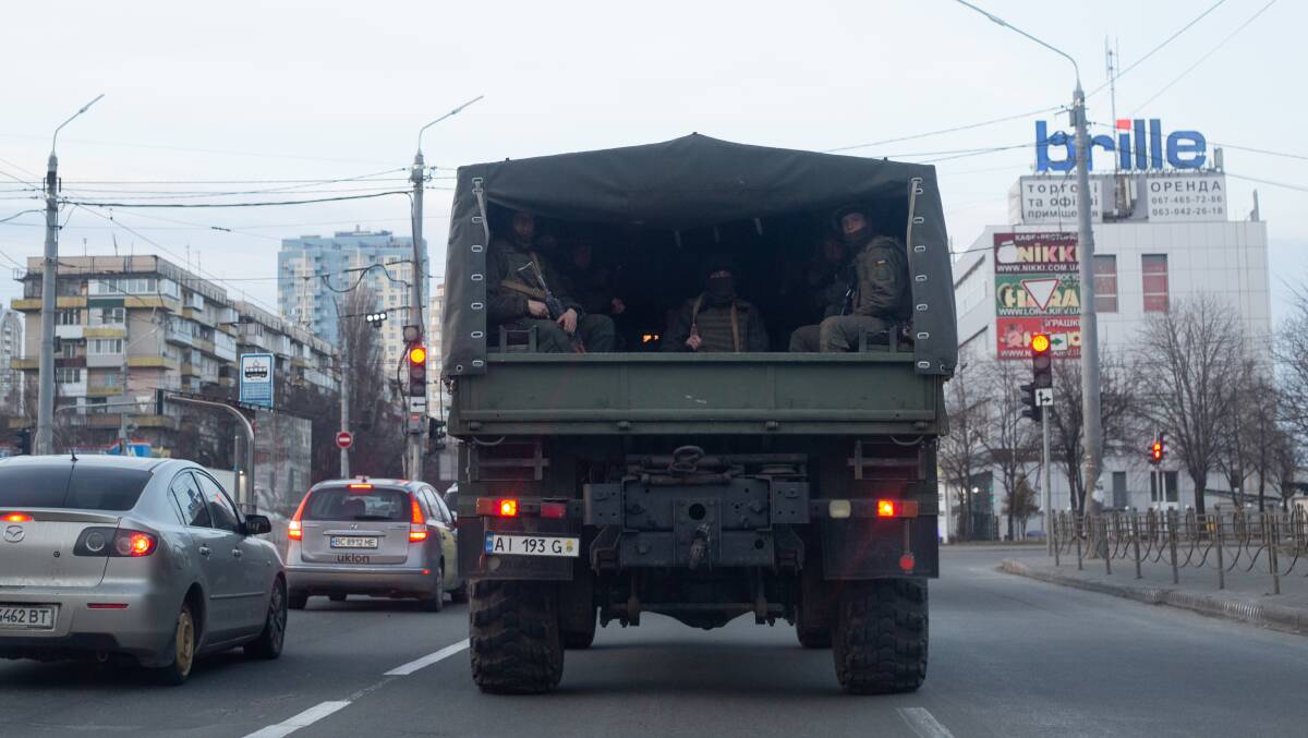 A military vehicle with Ukrainian servicemen drives through the road on February 25, 2022 in Kyiv. Picture: Getty Images