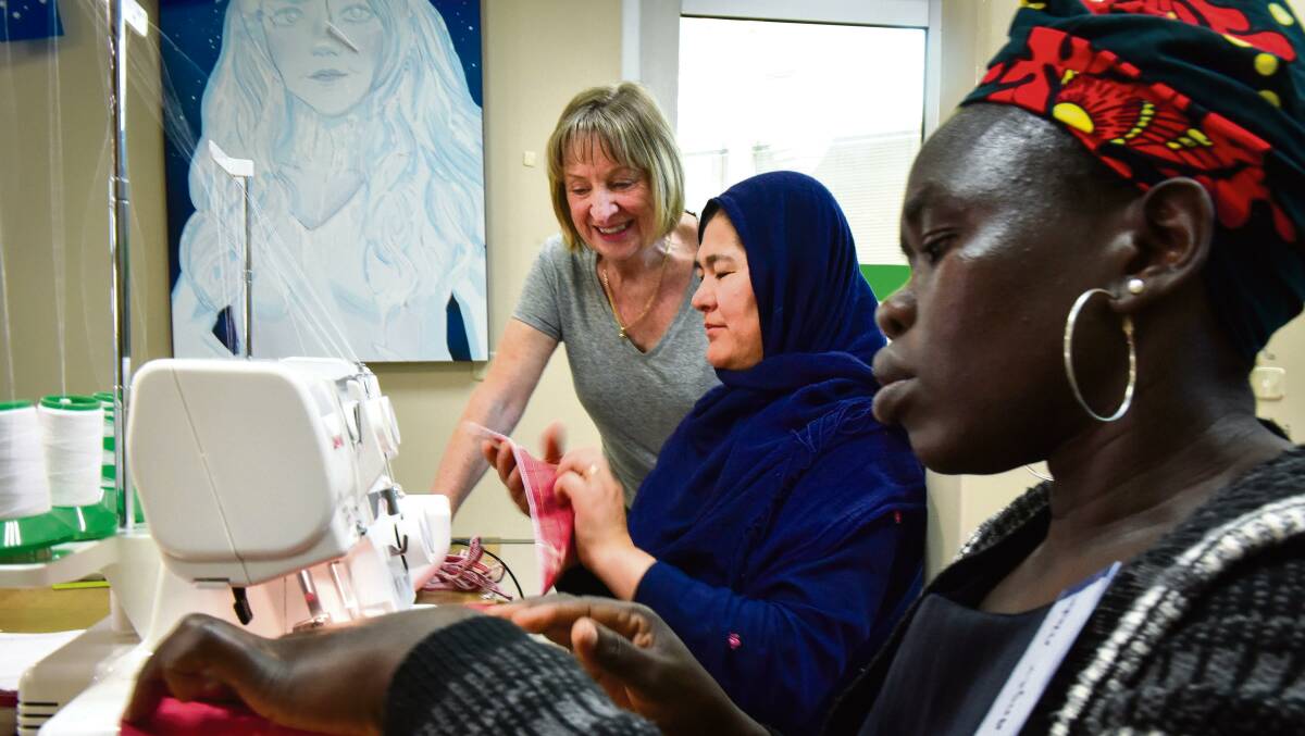 Volunteer sewing teacher Liz Steen with Zakia Sultani and Anger Madut working together making re-usable produce bags at Bendigo's SisterWorks weekly workshop. Photo by Brendan McCarthy