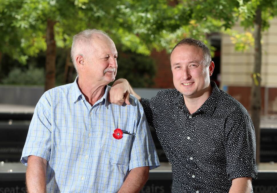 FATHERLY PRIDE: Graeme Warfe looks at his son, Mark, who became a nurse after his father suffered a severe stroke. Picture: GLENN DANIELS