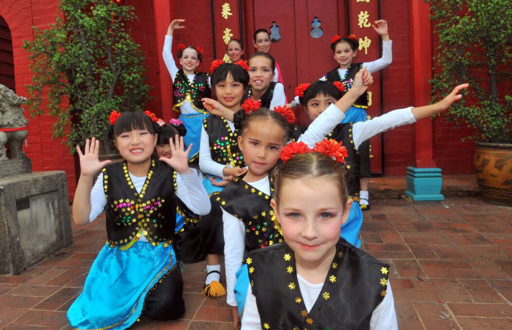 PERFORMERS: Claudia Scott sits in front of the rest of the Plum Blossom dance team from the Bendigo Chinese Association in front of the Joss House to celebrate the Chinese new year in 201. Picture: JIM ALDERSEY.