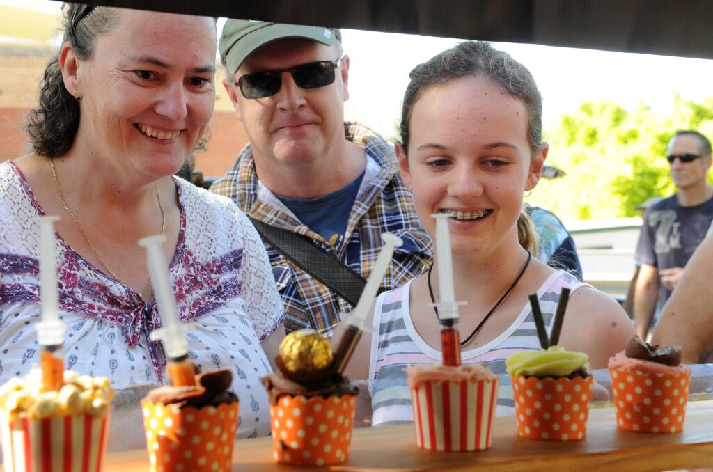 Cupcakes and foods at a local market, Samantha, Mark and Tessa. Picture: NONI HYETT