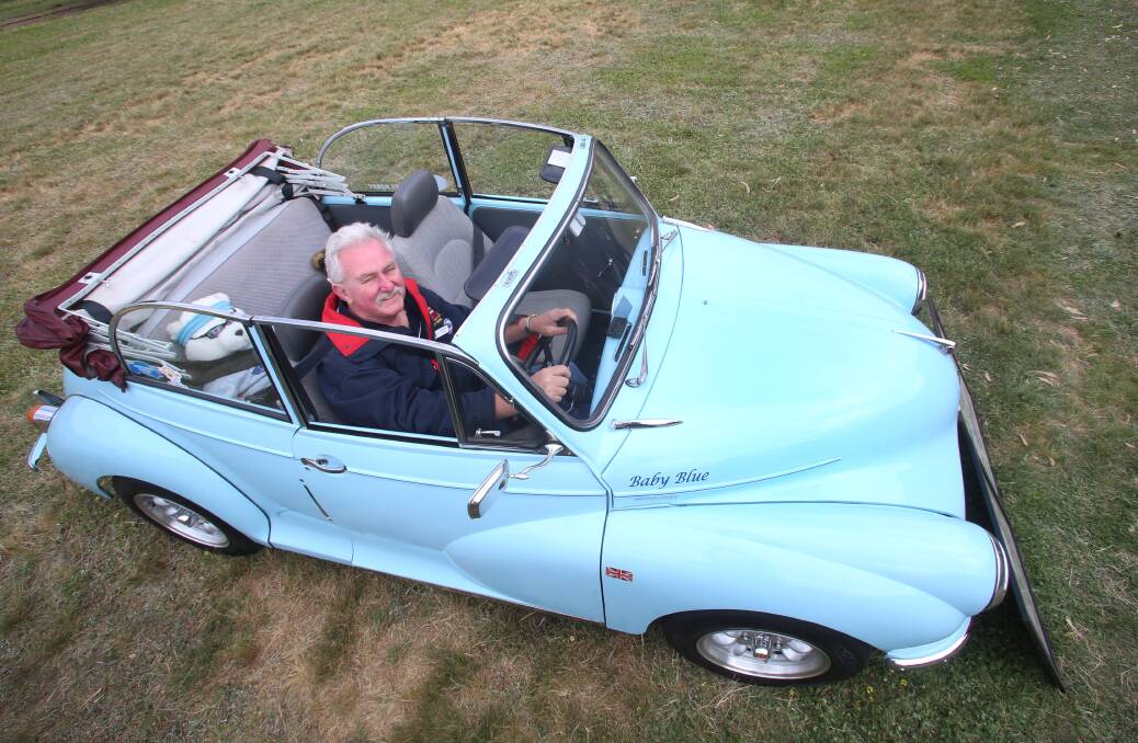 Graham Dines in his 1959 morris minor convertible called Baby Blue. Picture: PETER WEAVING