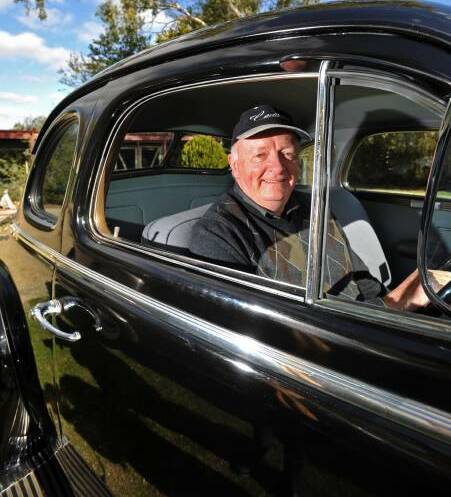 VINTAGE: Geoff Pollard sits proudly in his completely refurbished 1937 black Cadillac LaSalle. Pictures: JODIE DONNELLAN