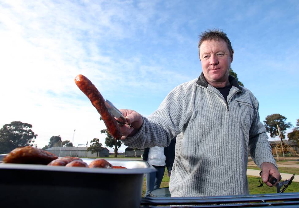 Shane Hommelhoff cooks up some snags at the 2016 election. Picture: GLENN DANIELS