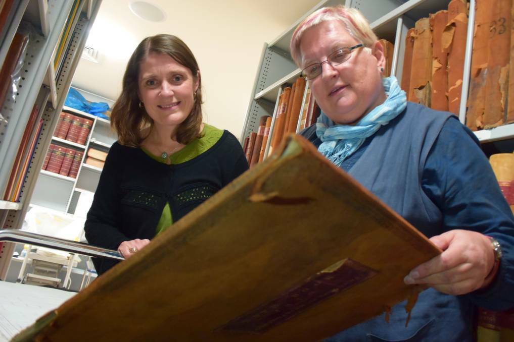 NEW DISCOVERIES: Emma Newman and Vivien Newton pour through old Sandhurst and Bendigo Council rates books in search of a family's history. Picture: TOM O'CALLAGHAN