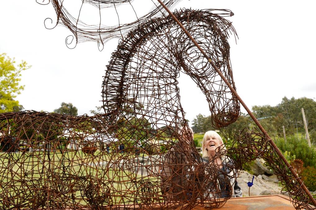 ARTWORK: Joy Wallace finds the funny side of one of the sculptures from 2017. Picture: DARREN HOWE