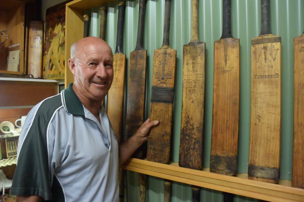 Peter Scullie stands beside some of the nearly 160 cricket bats in his own, private 'Bat Cave'. Picture: KIERAN ILES