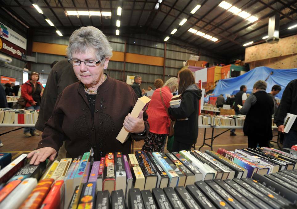 KEEN EYE: Mary Stevens browses through the boxes of books at the Easter fair 2014. Picture: JODIE DONNELLAN  