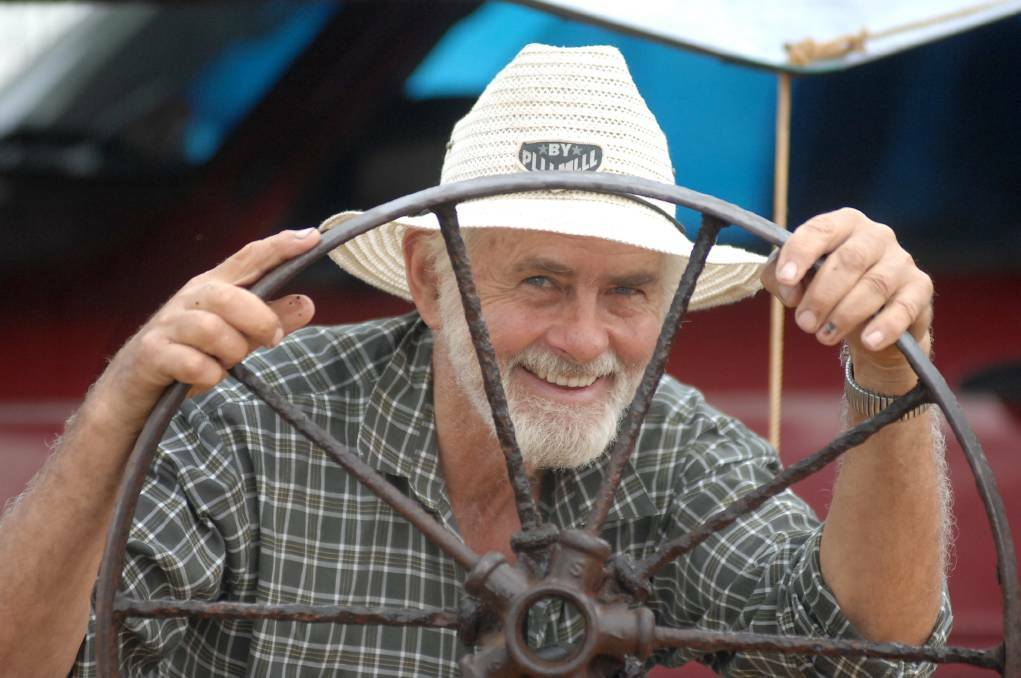 BUY AND SELL: 2007: Lindsay Hodge with a harvester wheel. Picture: BENDIGO ADVERTISER.