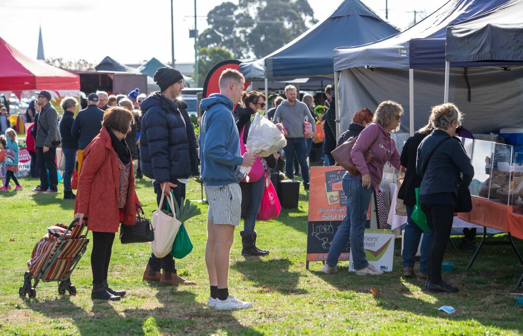 MANY GOODS: Community members attend a market in regional Victoria. Picture: PETER WEAVING