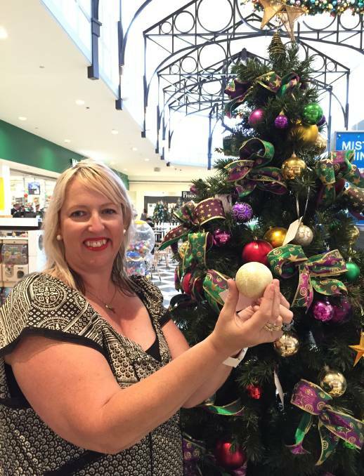  TRADITION: Tracy Harnetty hangs a Christmas bauble for her mother, father and sister, all of whom died of cancer. Picture: ERIN HANDLEY