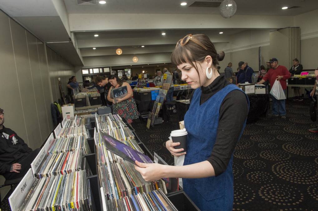 VINYL FINDS: Olivia Ryan has a look at the vinyl on display at the Bendigo Record Fair in 2019. Picture: DARREN HOWE