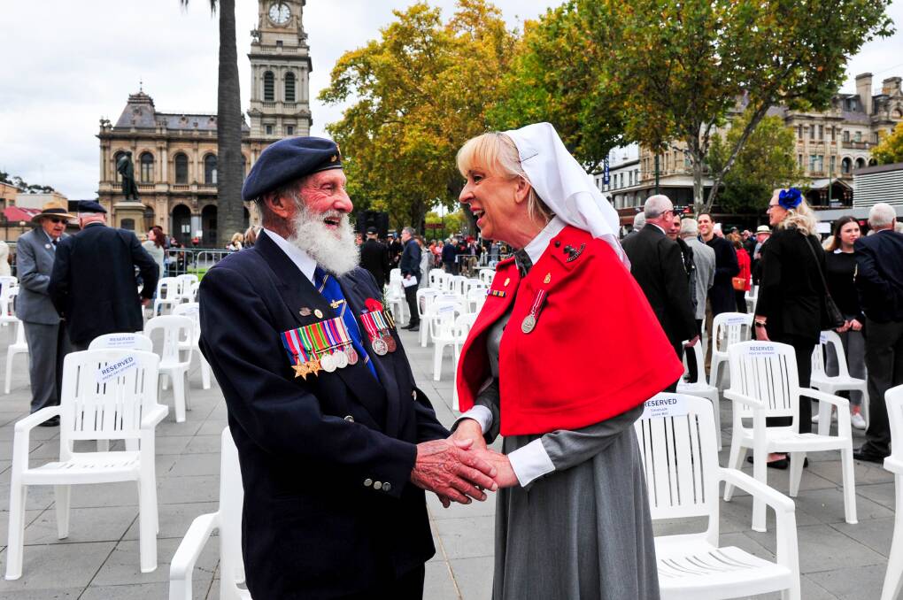 PAYING RESPECTS: "Dingle" Bell (ex RAAF National Serviceman 1952-59) and Lisa Gellatly of the Army Nursing Corp (in period costume) at the Anzac Day Service in Bendigo 2021. Picture: BRENDAN McCARTHY