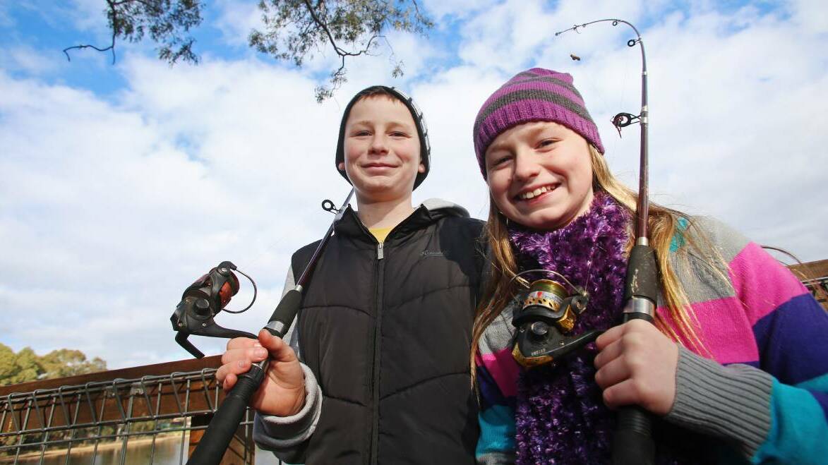 GONE FISHING: Oscar, 13, and Macey, 10, spent some school holiday time fishing at Kennington Reservoir in 2015. Picture: DARREN HOWE.