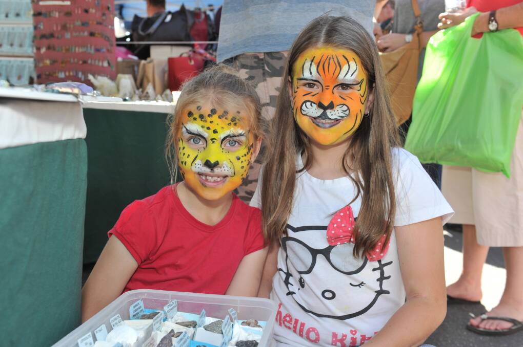 FACE PAINTING: Bella and Kathleen Clancy get their faces painted at a market. Picture: JODIE DONNELLAN
