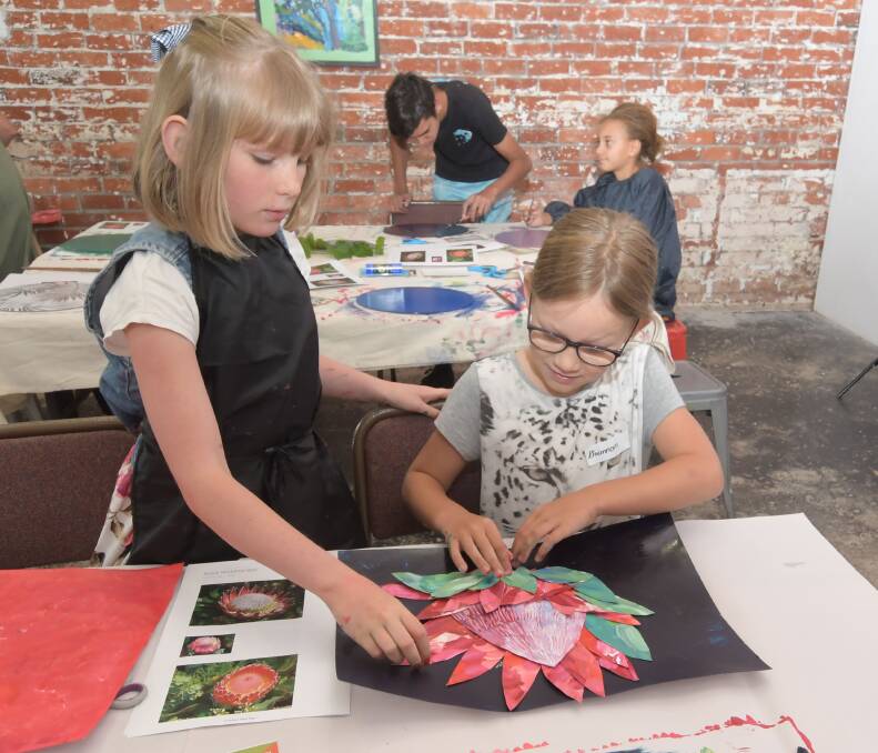 Arnold Street Gallery host a school holiday program where kids make Protea artworks from paper and acrylic paints in 2019, Audrey Savage and Rhiannon Truscott. Picture: NONI HYETT