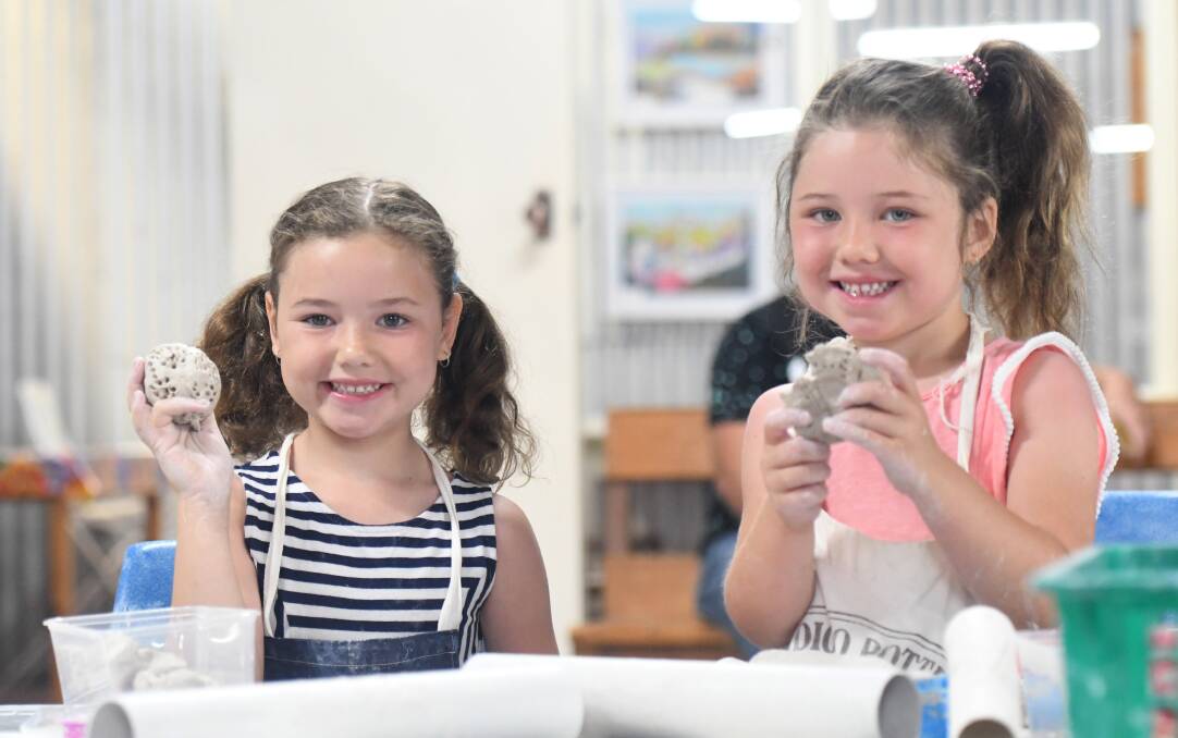 NEW SKILL: Indianna and Harper Hillman enjoy the school holiday activity at Bendigo Pottery. Picture: NONI HYETT