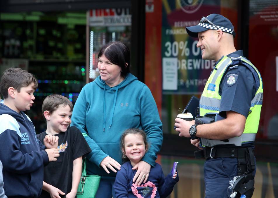 Constable Greg Broom chats with the Jacob, Corey, Linda and Heidi. Picture: GLENN DANIELS.