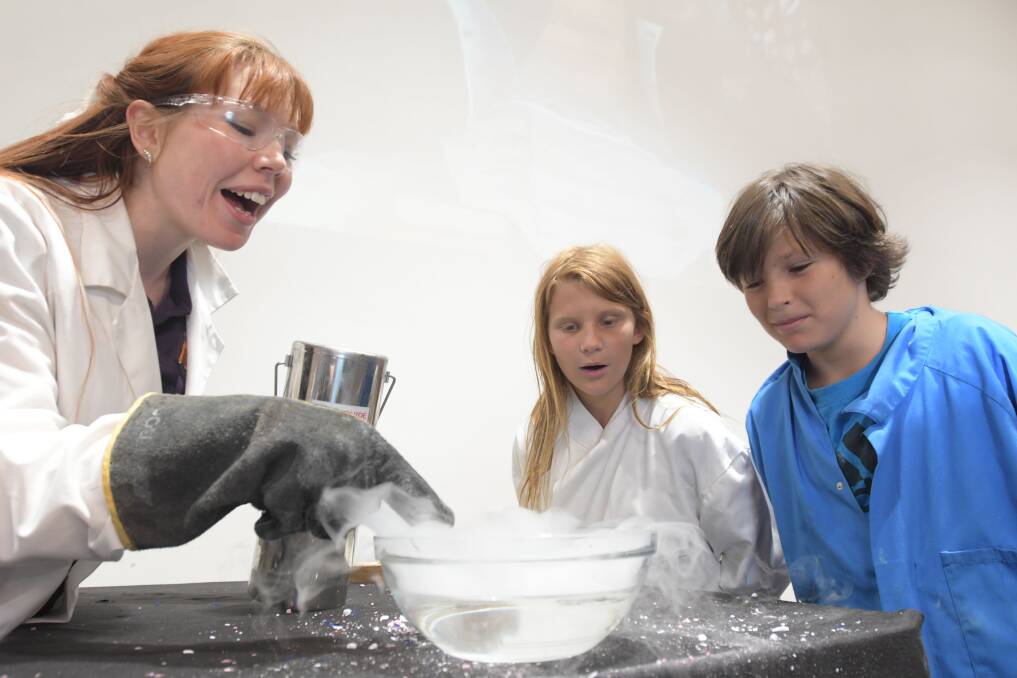 Lillian and Louis Walker have a close look at some liquid nitrogen. Picture: NONI HYETT