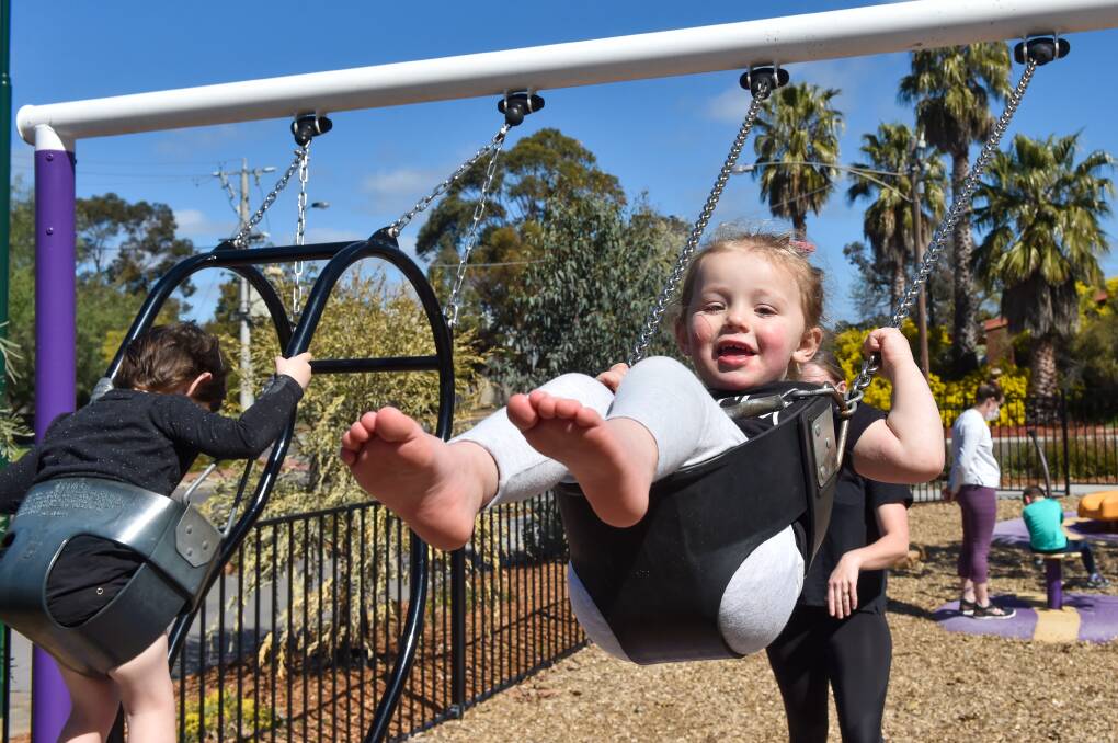 FUN TIMES: Evie Bartlett has fun on swings. Picture: DARREN HOWE