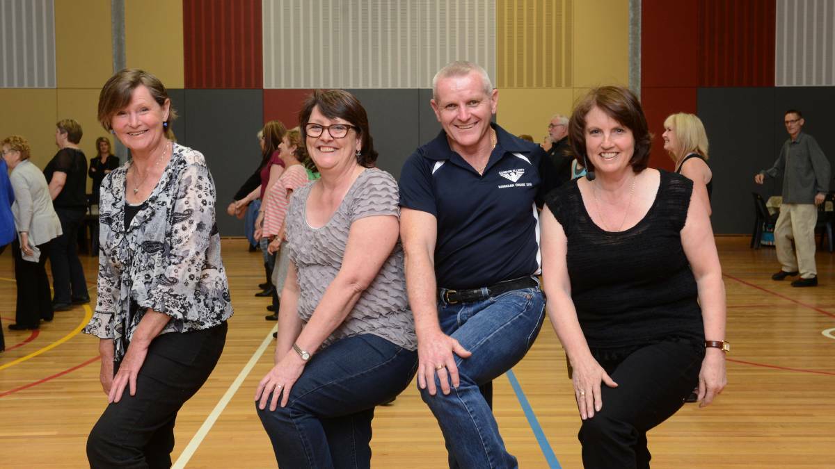  KNEES UP: Gordon Elliott shares a move with Marion Whitzell, Robyn Ross, and Joanie Lobb in 2013. Pictures: JIM ALDERSEY