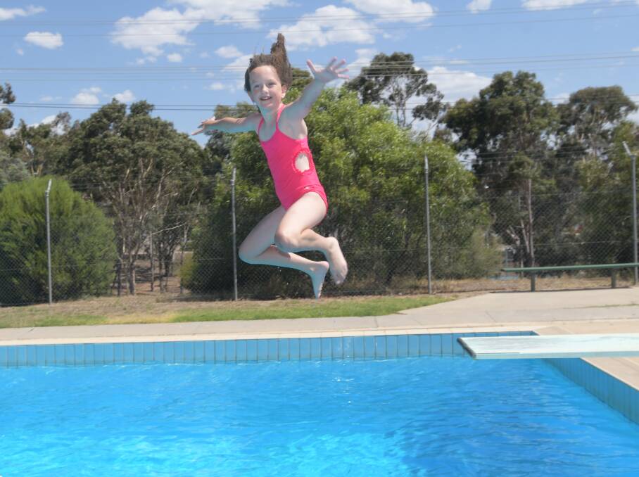 SPLISH SPLASH: Ruby Dyett leaps into the Brennan Park Pool. Picture: NONI HYETT