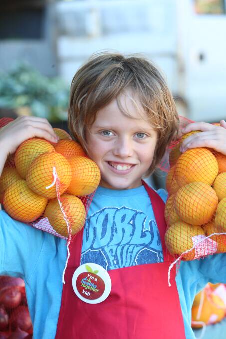 PRODUCE: Kalo Davis shows off some oranges. Picture: GLENN DANIELS