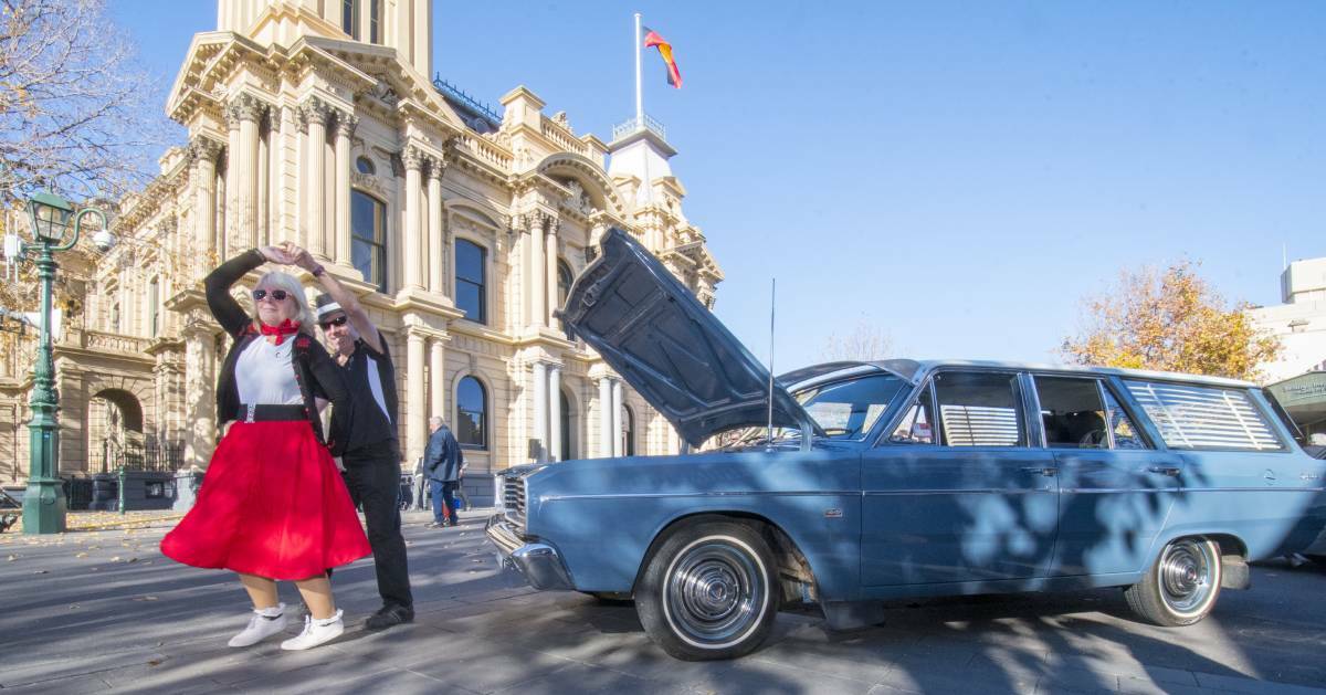 VINTAGE: Shelley Thompson and Vinny Keating from the Bendigo Jailhouse Rockers dance alongside a South Australian Chrysler in front of Bendigo Town Hall. Pictures: DARREN HOWE. Click image for full story.