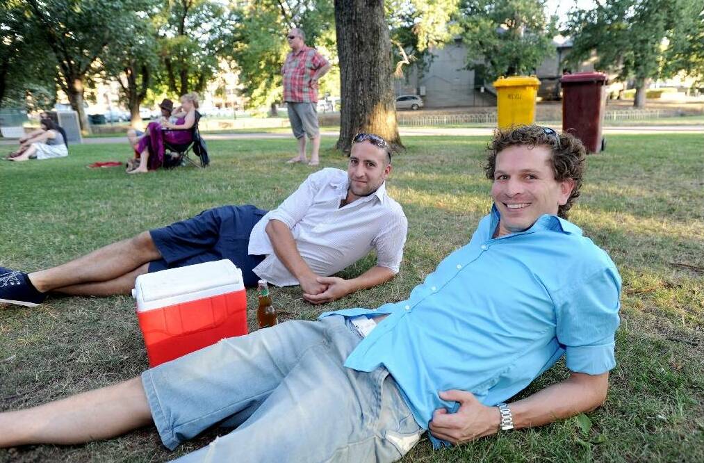 RELAXED:  Billy Lordan and Mike Reid relax on the grass at a concert in 2013. Picture: BENDIGO ADVERTISER.
