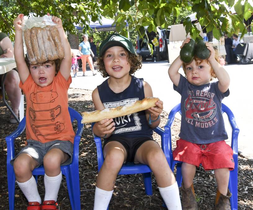 FRESH: Brothers Quentin, Reuben and Augustus Carrick enjoy a market. Picture: NONI HYETT