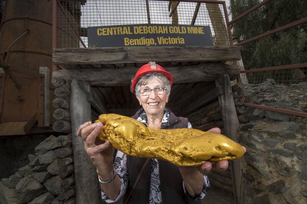 Bep Hillier and a replica gold nugget at Central Deborah Gold Mine. Picture: DARREN HOWE