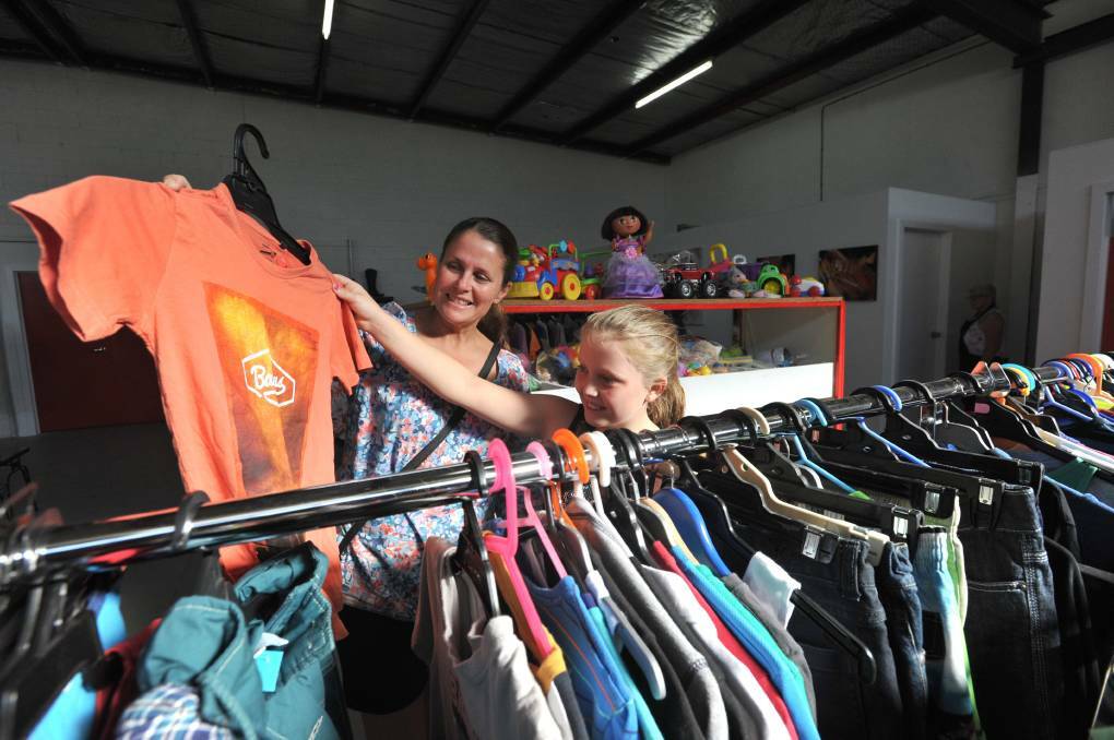 Karen Machin and her daughter Jaida Tuohey have a look at clothing on offer. Picture: NONI HYETT
