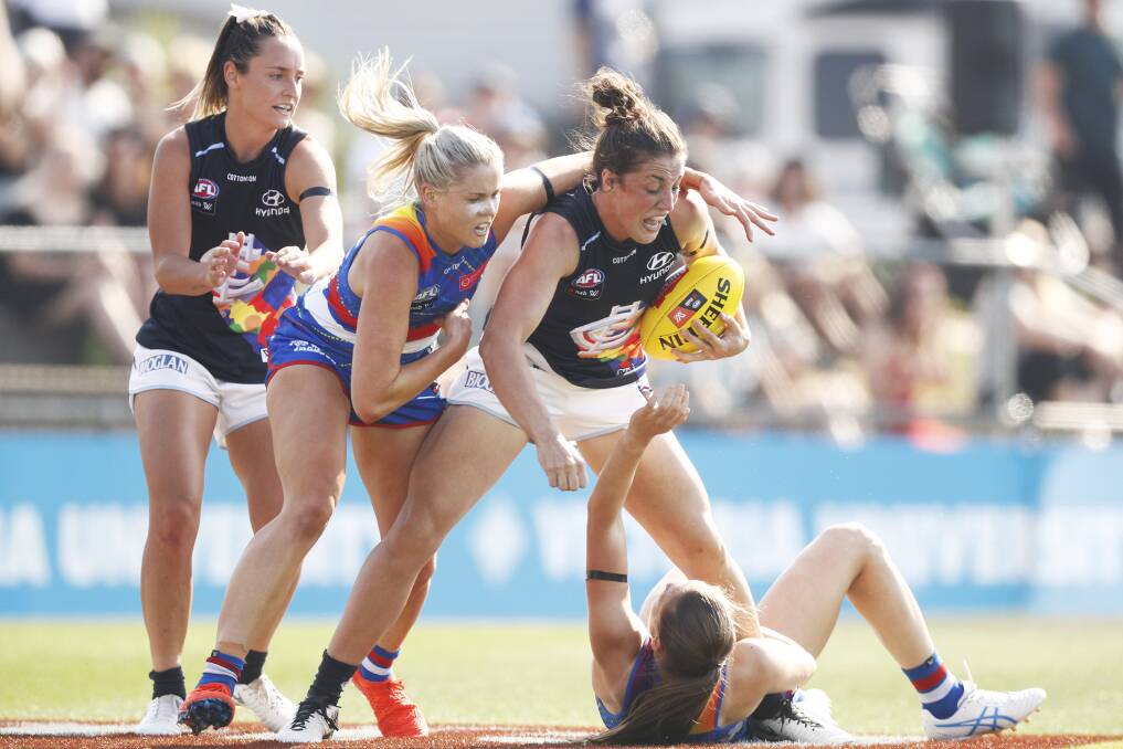 Kerryn Harrington tackled by Katie Brennan of the Bulldogs during  Round seven match clash against Western Bulldogs. PICTURE: AAP/DANIEL POCKETT