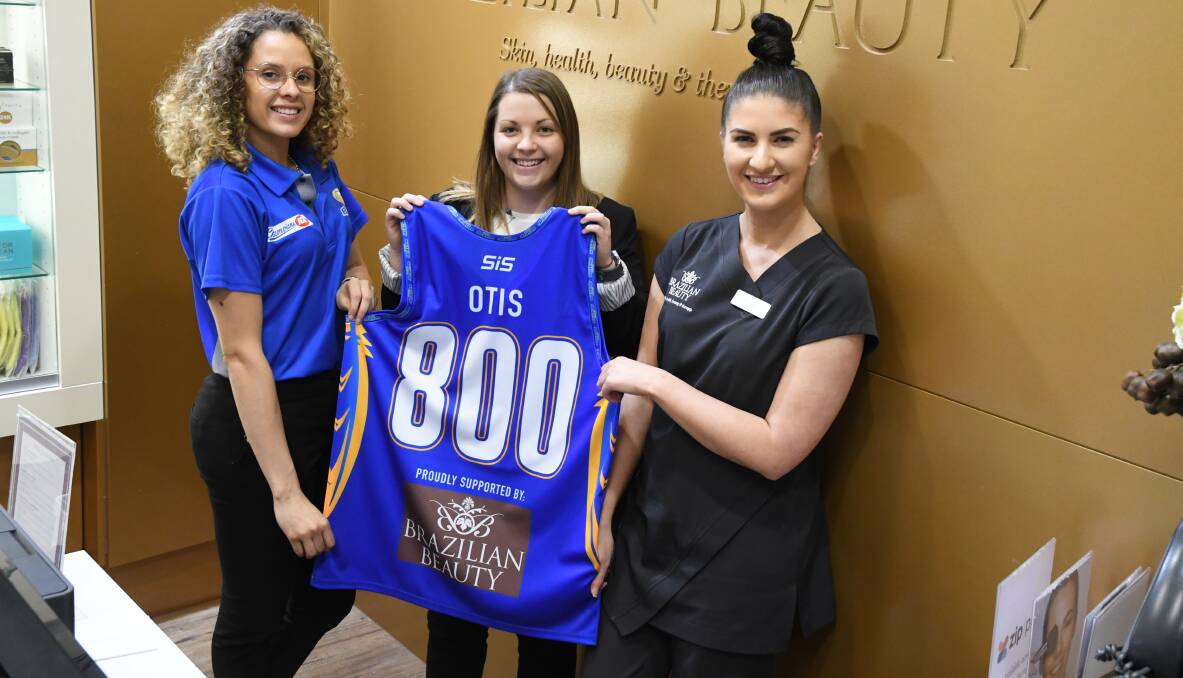 AUCTION: Bendigo Braves' Bianca Dufelmeier with OTIS's Mandy Mitchell and event sponsor Brazilian Beauty's Rainer Tibbett with the jersey to be auctioned at half time. Picture: KIERAN ILES
