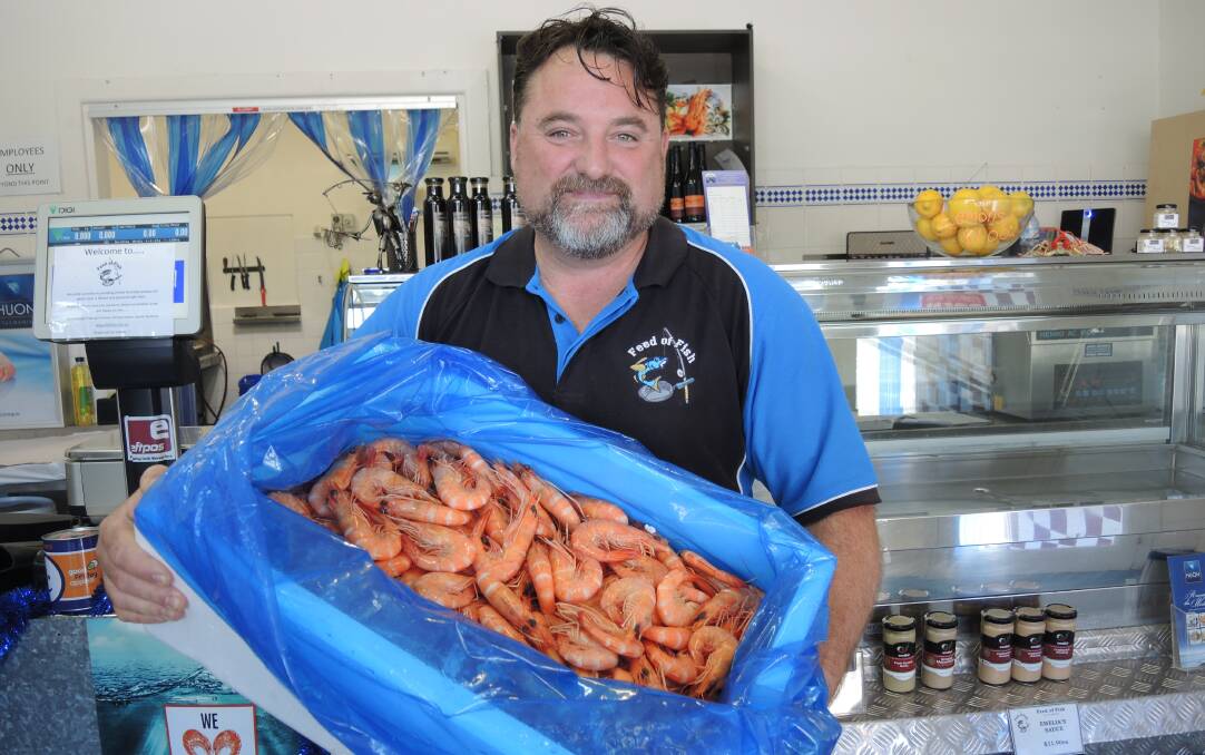 FRESH CATCH: Feed of Fish owner Wayne Kelly with his first batch of fresh Queensland banana prawns. Picture: ANTHONY PINDA