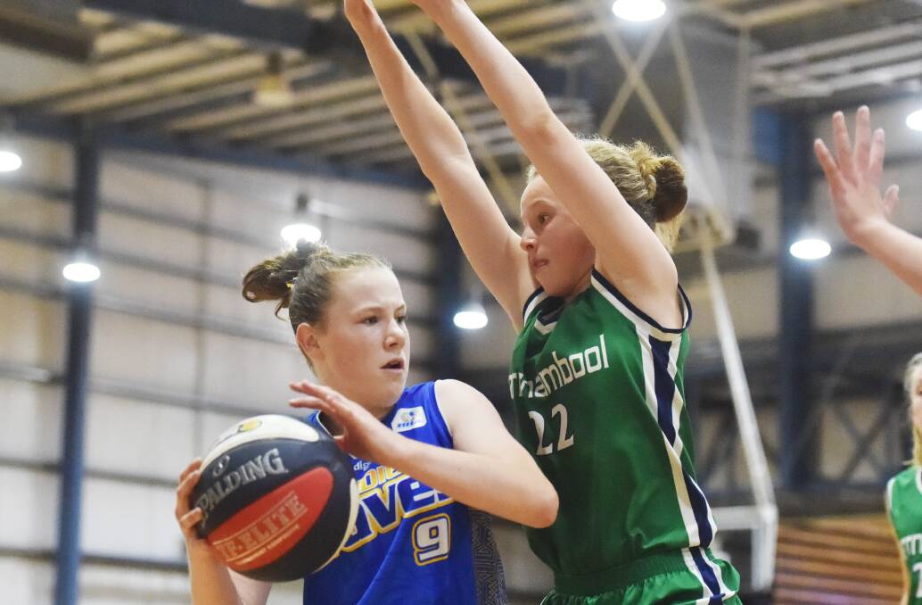 PRESSURE: Amelia Grist looks for options while under pressure from Warrnambool's Poppy Myers during the U/14 Girls Championship match.