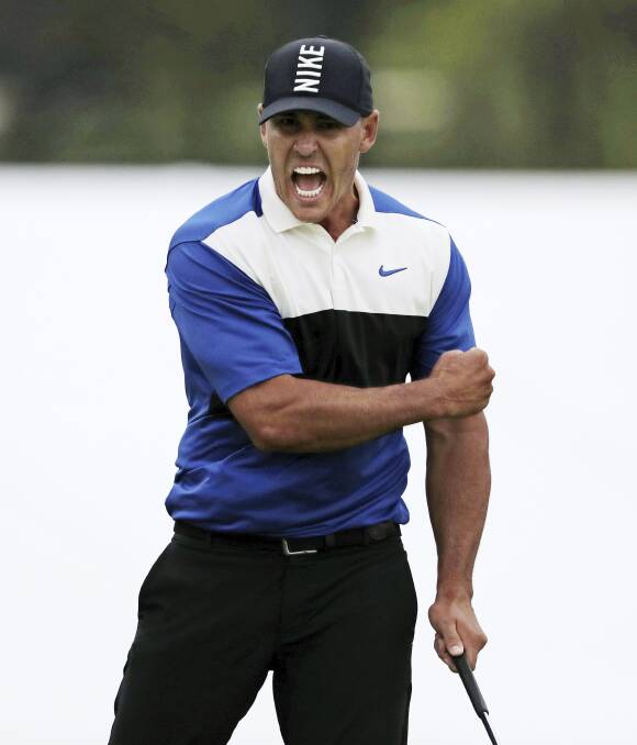 WINNING FEELING: Brooks Koepka celebrates after sinking his putt on the 18th to win the 2019 PGA Championship. Picture: AP/CHARLES KRUPA