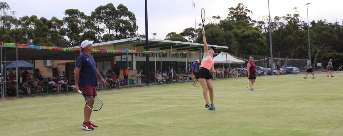 VICTORY: Nicole Mullen reaching for a smash during the open mixed doubles which she won alongside her father Michael.