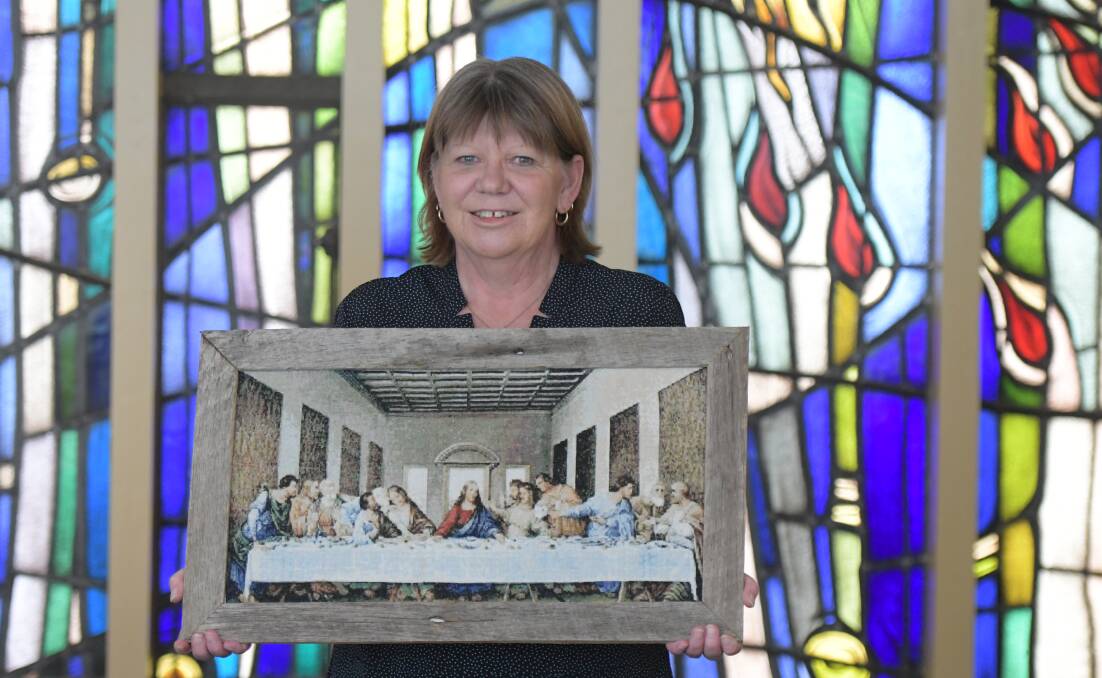 THE LAST SUPPER: Enrolled nurse Beris Wyatt with the cross stitch completed and donated by a patient of St John of God Bendigo Hospital. Picture: NONI HYETT